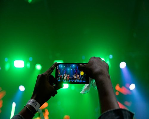 Central smartphone screen showing a fictional CROWN event guide